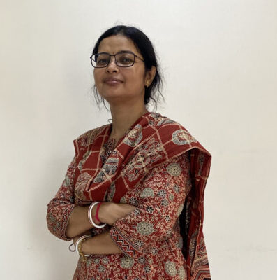 Woman in red traditional attire standing indoors