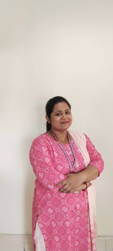 Person in pink patterned outfit smiling