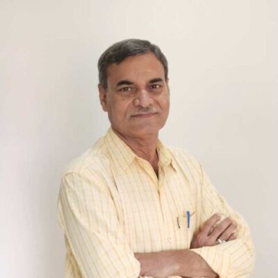 Smiling man in yellow shirt, arms crossed