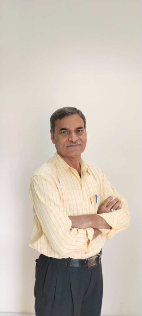 Smiling man in yellow shirt, arms crossed