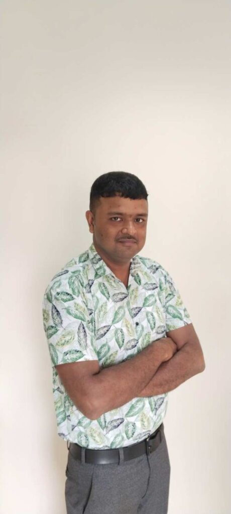 Man in leaf patterned shirt crossing arms