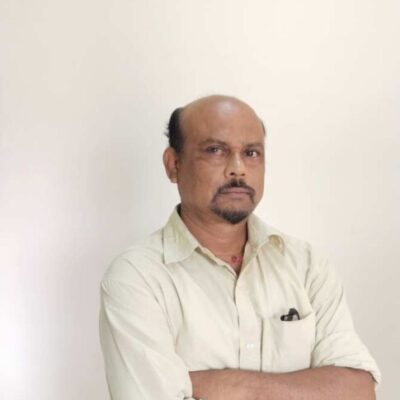 Man with crossed arms in white shirt.