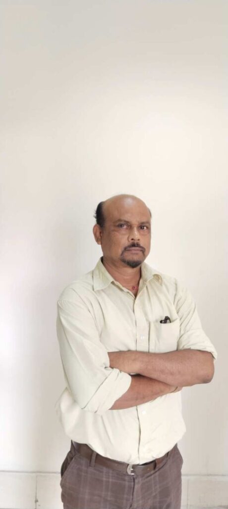 Man with crossed arms in white shirt.