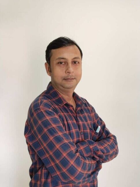 Man in checkered shirt with arms crossed