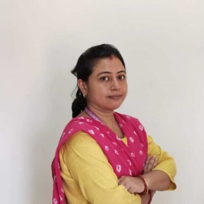 Woman in yellow attire with red scarf