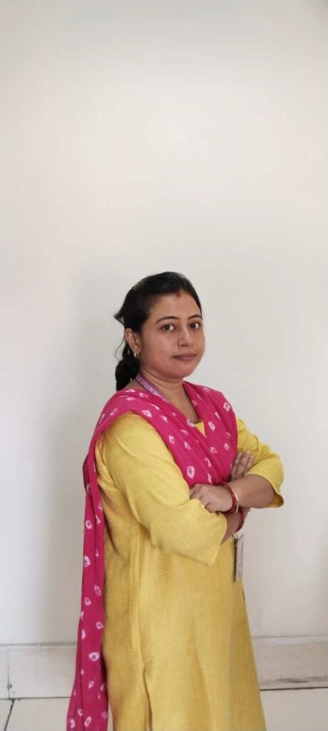 Woman in yellow attire with red scarf