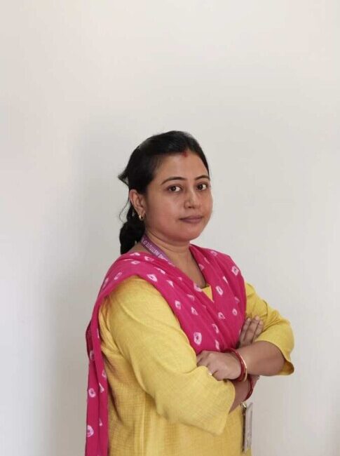 Woman in yellow attire with red scarf