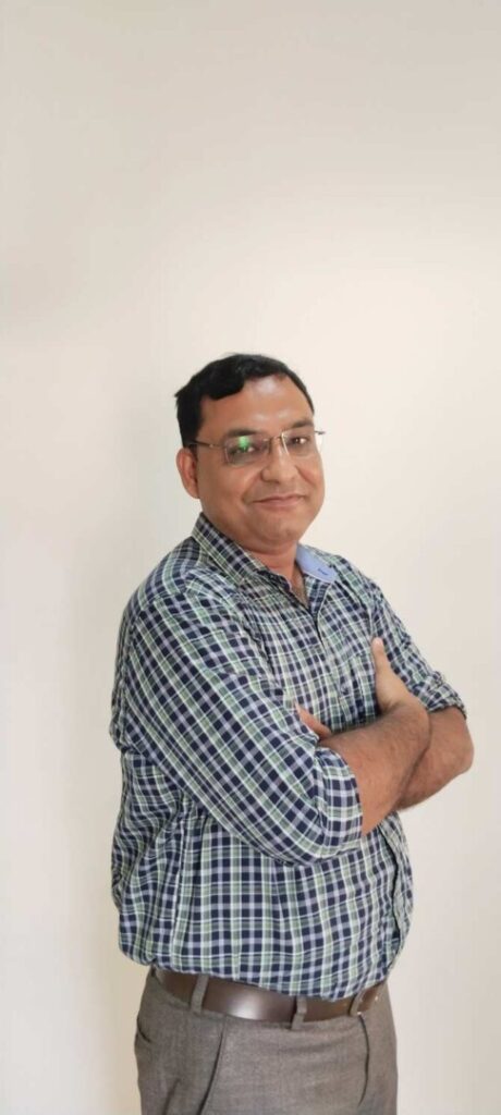 Person in checked shirt with crossed arms