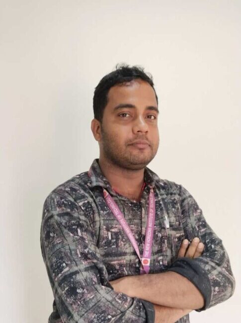 Man with folded arms and ID badge