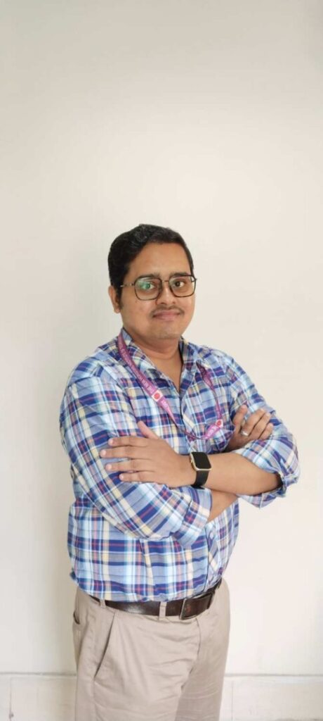 Man in plaid shirt with arms crossed