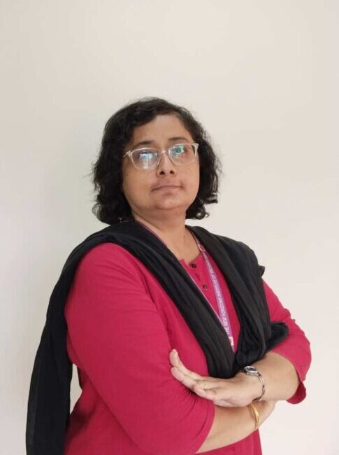 Woman in red kurta with black scarf.