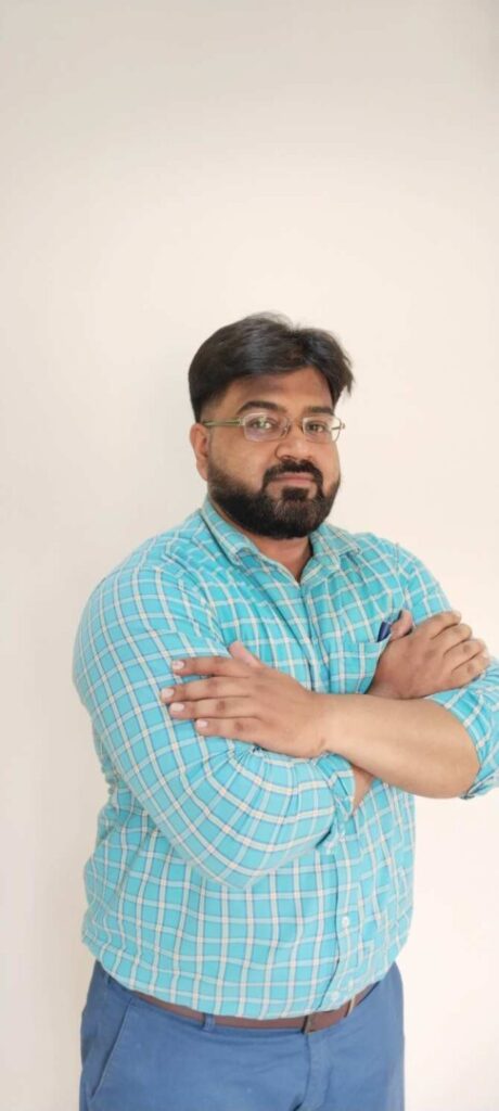 Man in plaid shirt with crossed arms