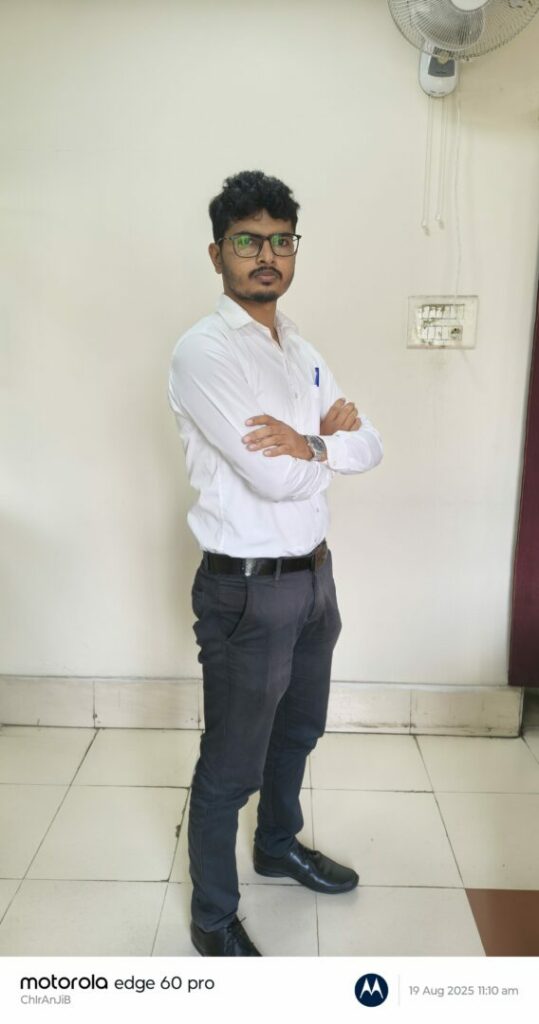 Man posing indoors with arms crossed.